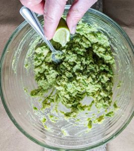 mashing avocado for homemade guacamole recipe